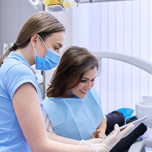 A woman consulting her dentist about a treatment’s price